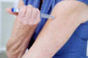 Woman injecting insulin